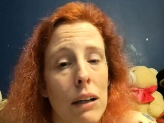 Pretty red-haired web cam getting off display
