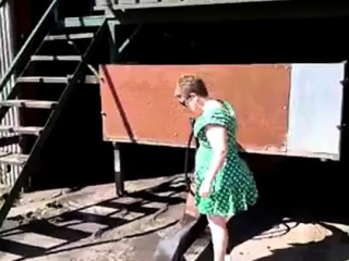 Showing in green sundress and milky high-heeled shoes