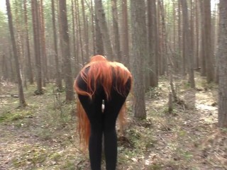 Red-haired nymph with lengthy hair ambling in the park