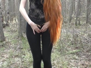 'Redhead damsel with lengthy hair ambling in the park'